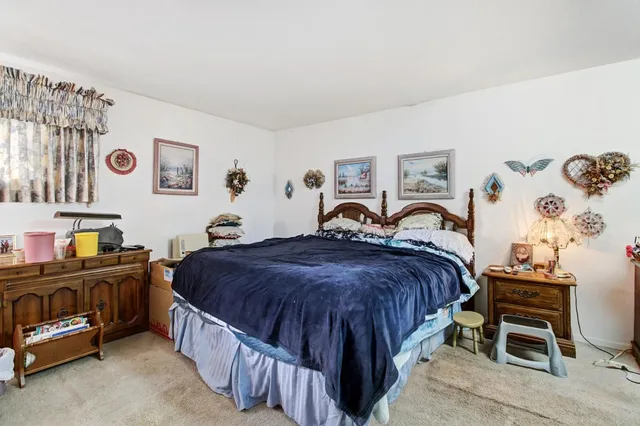 a view of a backyard with wooden fence and trees