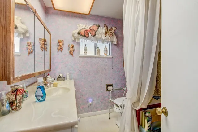 a bathroom with a sink a mirror and a vanity
