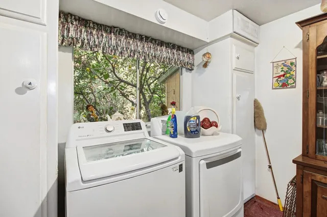 a kitchen with stainless steel appliances granite countertop a refrigerator a stove a sink a dining table and chairs