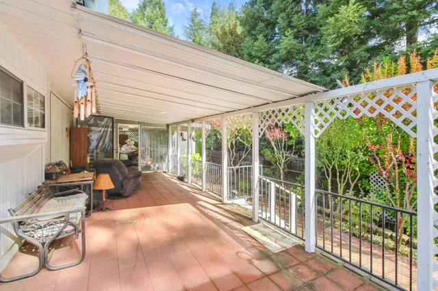 a view of a patio with table and chairs and potted plants