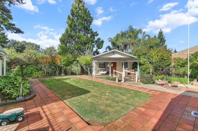 a kitchen with stainless steel appliances granite countertop a refrigerator and a stove