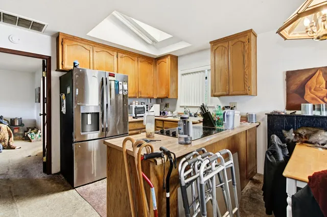 an aerial view of a house with a yard and a large tree