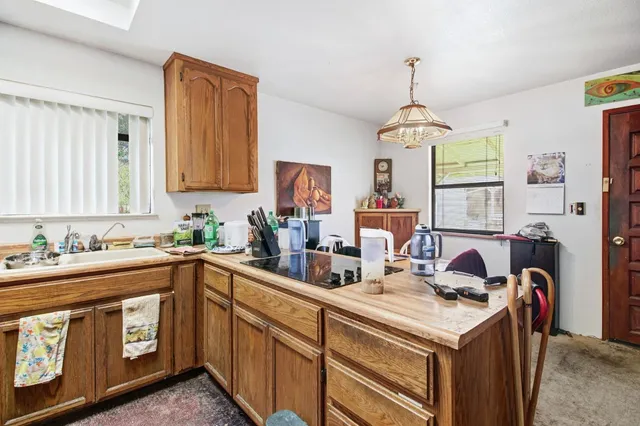 an aerial view of a house with a yard basket ball court and outdoor seating