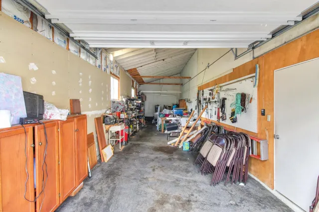 an aerial view of a house with a yard and trees all around