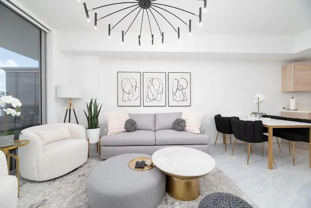 a living room with furniture and a chandelier