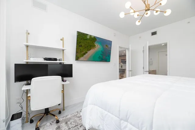 a bedroom with a bed and a chair