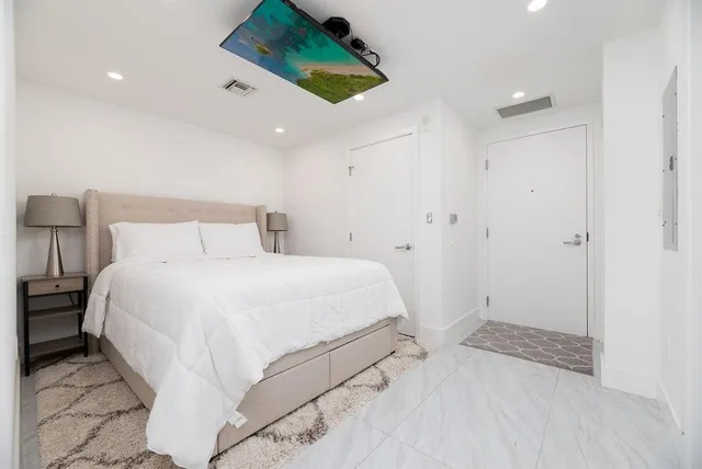 a bedroom with a bed and a painting