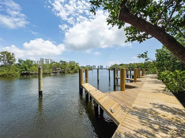 a view of a patio with a table chairs and a backyard