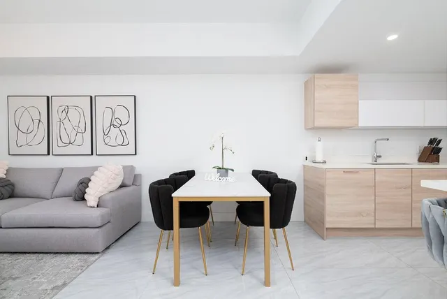 a living room with furniture a dining table and chairs