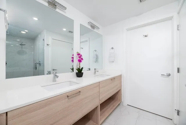 a bathroom with a granite countertop sink and a mirror