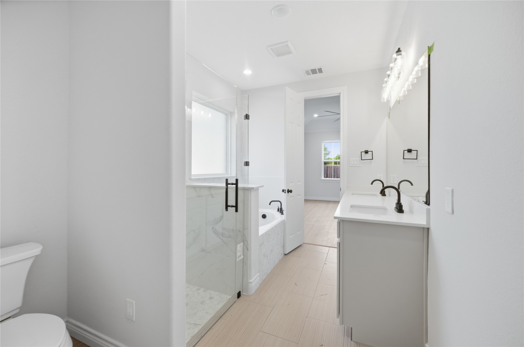 114 Par Circle La Porte, TX 77571 - Photo 20 of 33 Designer touches of tile flooring, black accent light fixtures, and faucets complete the beauty of the primary en suite.
