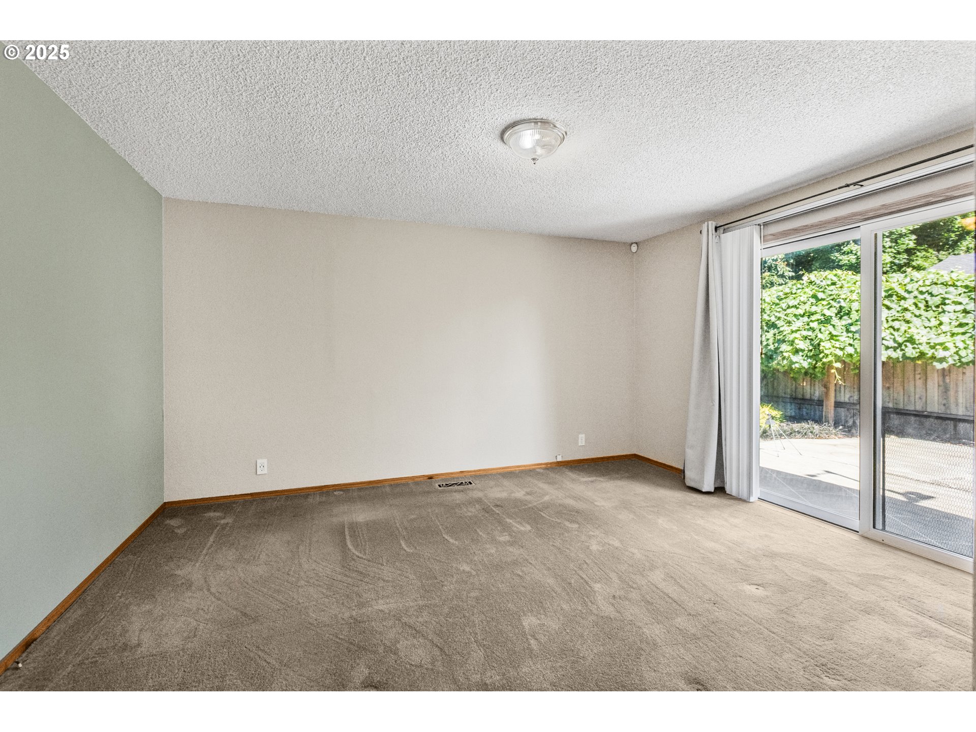 376 49th State Loop Springfield, OR 97478 - Photo 25 of 48 a view of an empty room with wooden floor and glass door