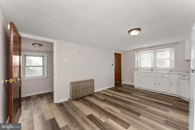 a view of a livingroom with wooden floor and window