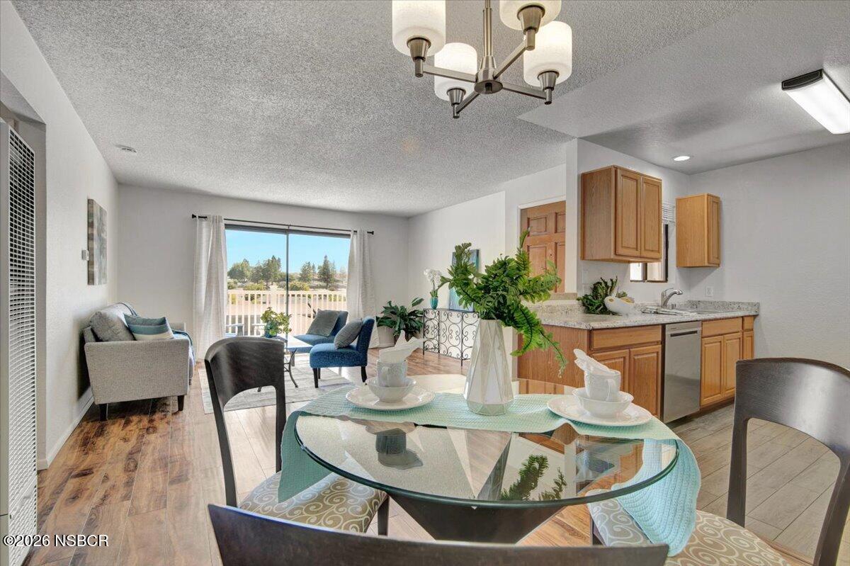 3400 Santa Maria Way, Unit 207B Santa Maria, CA 93455 - Photo 16 of 50 a dining room with furniture a large window and wooden floor