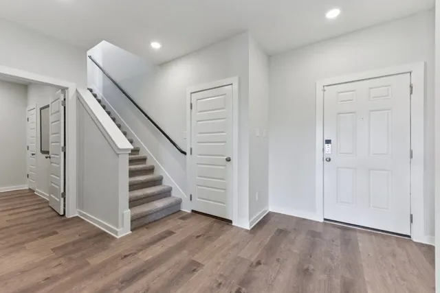 a view of a room with wooden floor and entryway