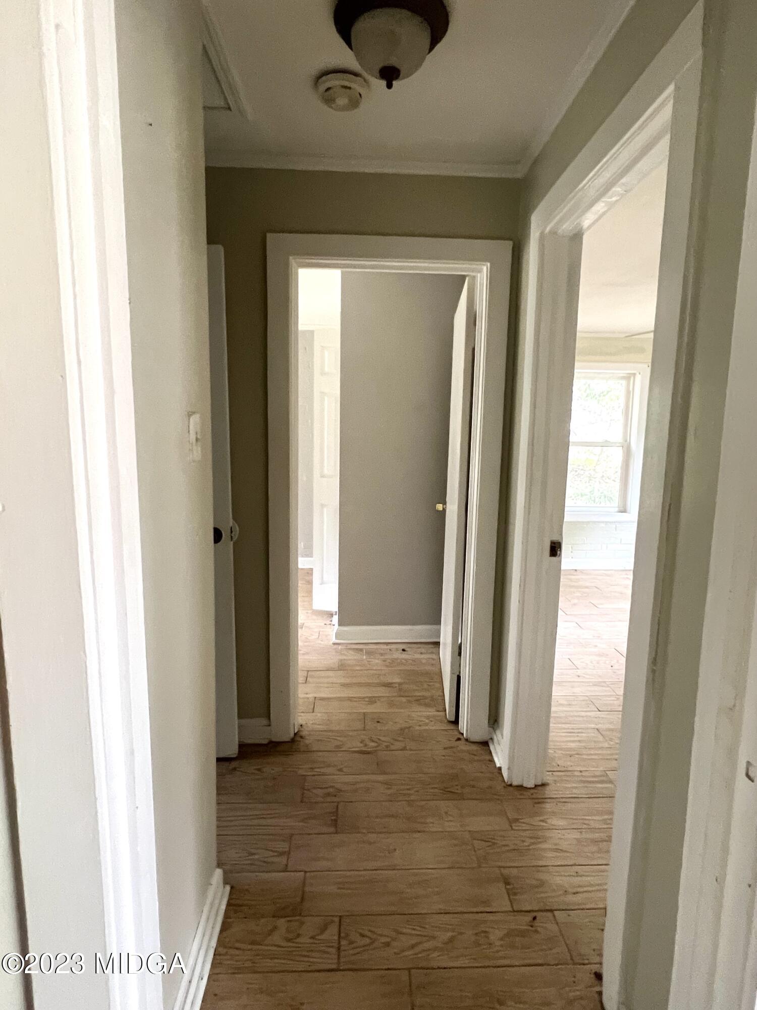 7615 Columbus Road Lizella, GA 31052 - Photo 40 of 56 a view of a hallway with wooden floor and a cabinet