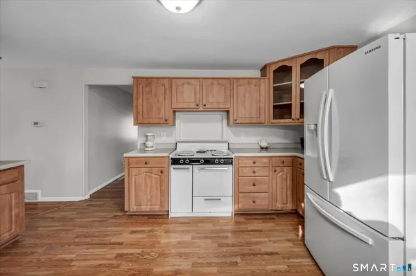 a kitchen with granite countertop a refrigerator stove and sink