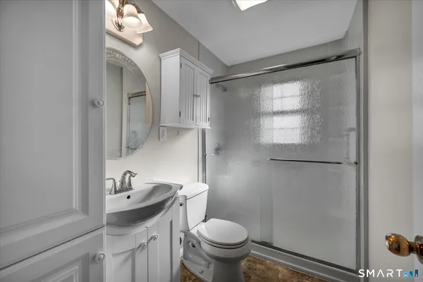 a bathroom with a sink toilet and shower