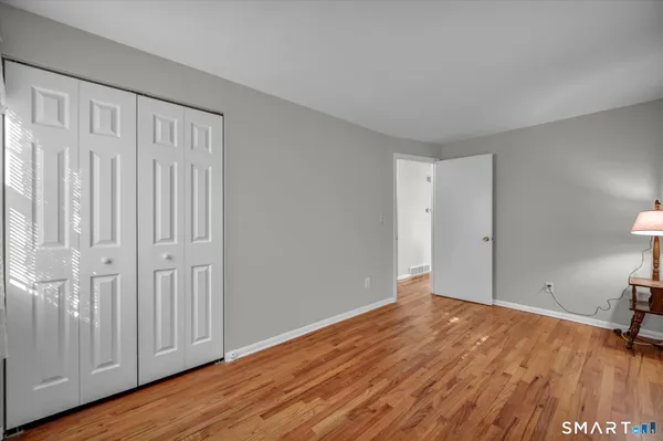 a view of an empty room with wooden floor