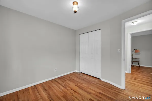 a view of a room with wooden floor