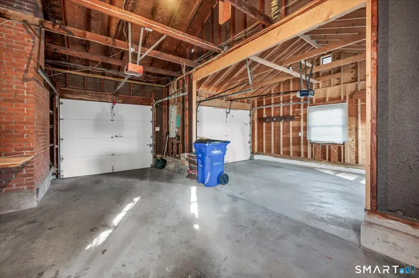 a view of water heater room with wooden floor