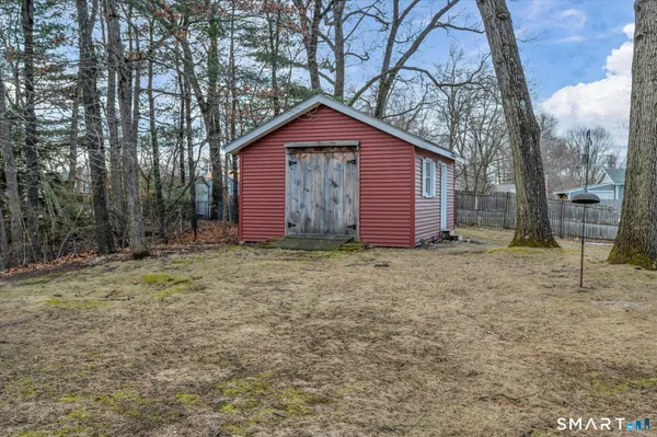 a view of barn house with a yard