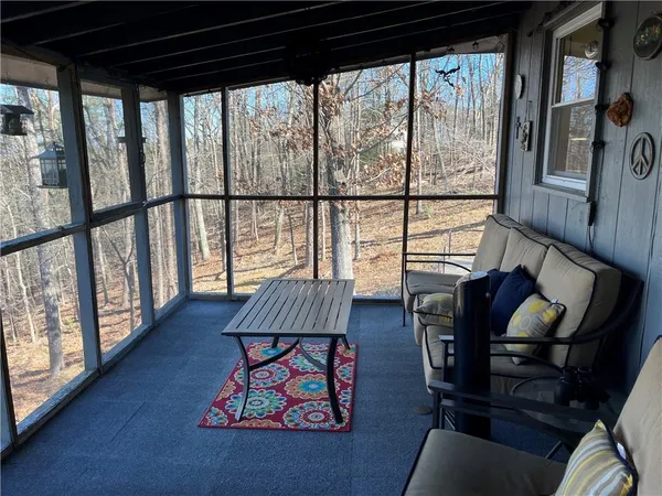 a living room with furniture and a floor to ceiling window