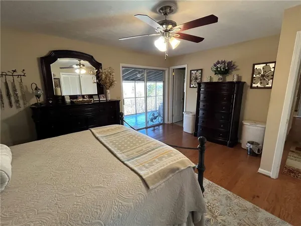 a bed room with a bed mirror and a chandelier