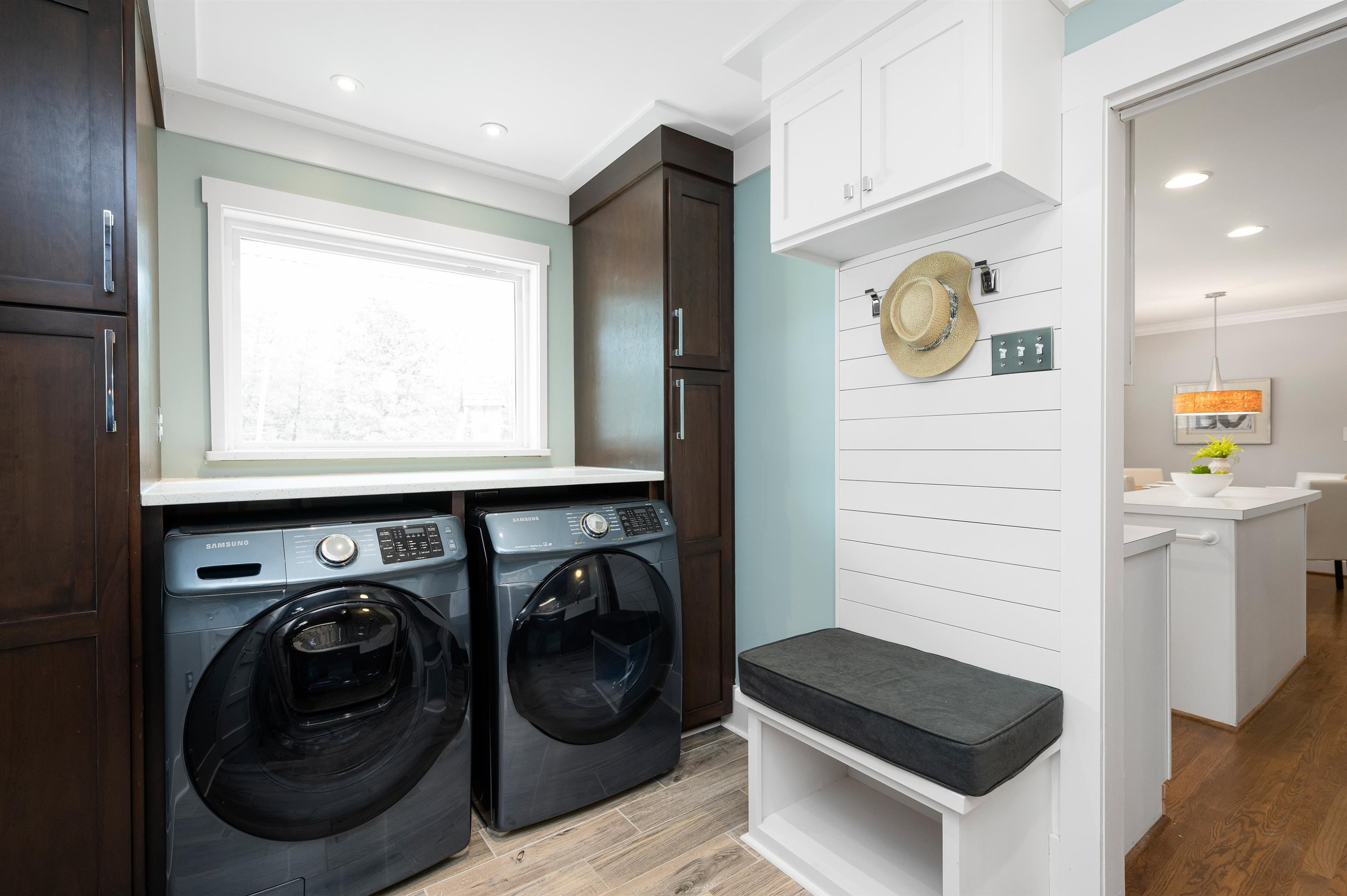 4907 Rembert Drive Raleigh, NC 27612 - Photo 18 of 52 Gorgeous laundry room with utility sink, counterspace, cabinets and mudroom bench Laundry Room