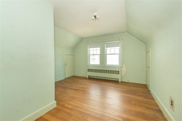 20 Overlook Road Arlington, MA 02474 - Photo 12 of 17 a view of an empty room with a window and wooden floor