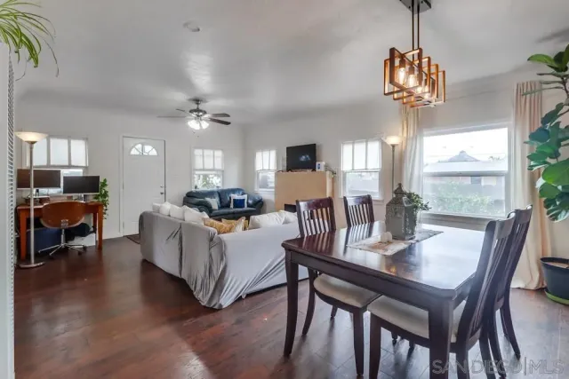 a living room with furniture a chandelier and a table