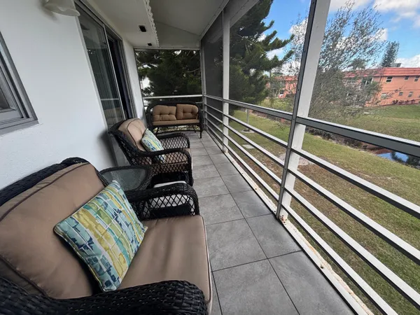 a view of sitting area with furniture and wooden floor