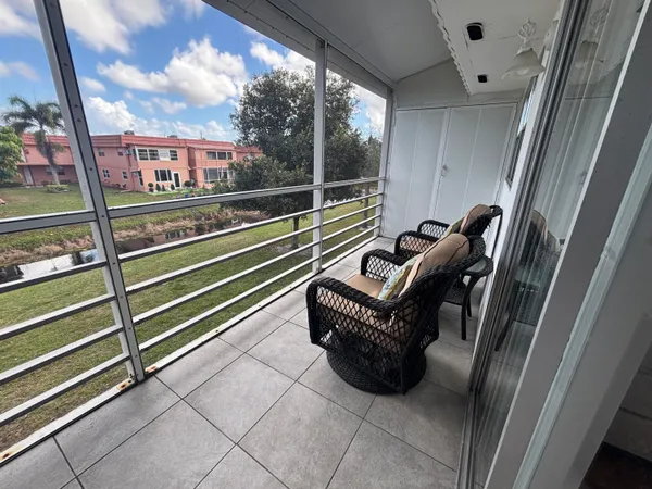 a view of a balcony with chairs
