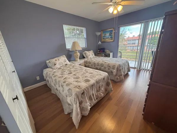 a bedroom with two beds and a large window