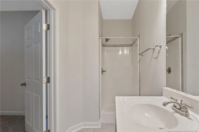 a bathroom with a sink and shower