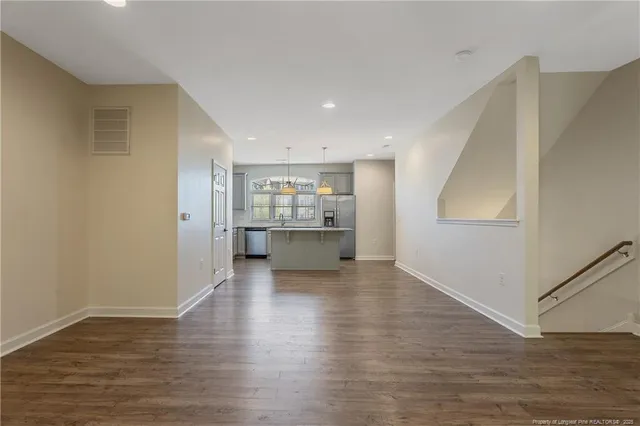 a view of kitchen with wooden floor and electronic appliances