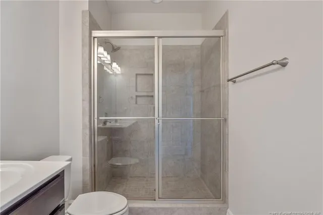 a bathroom with a toilet and a shower