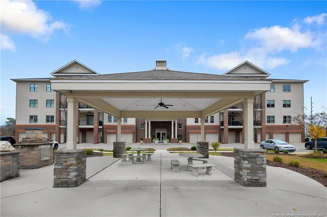 a view of a patio with dining table and chairs