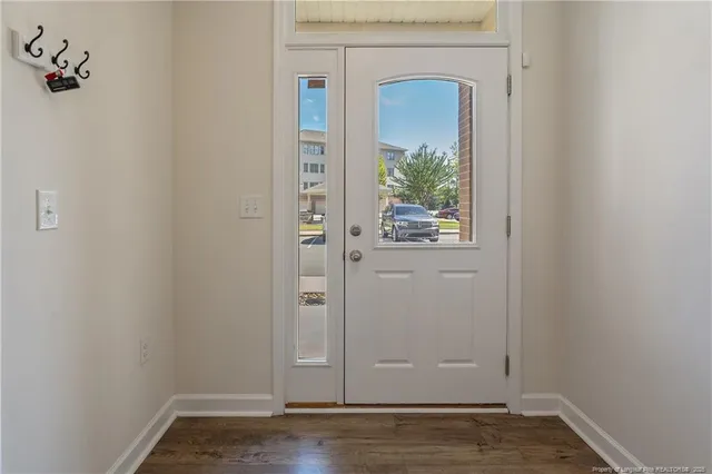 a view of a small space with wooden floor and a window
