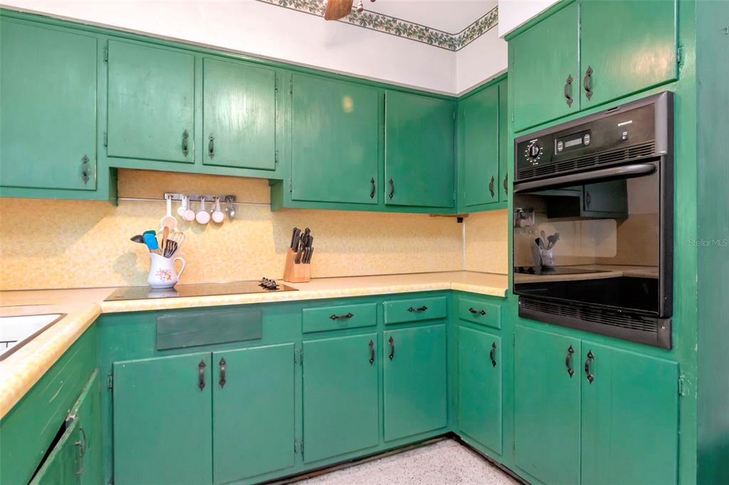 230 Milwaukee Avenue Dunedin, FL 34698 - Photo 17 of 61 a kitchen with stainless steel appliances white cabinets and a microwave oven