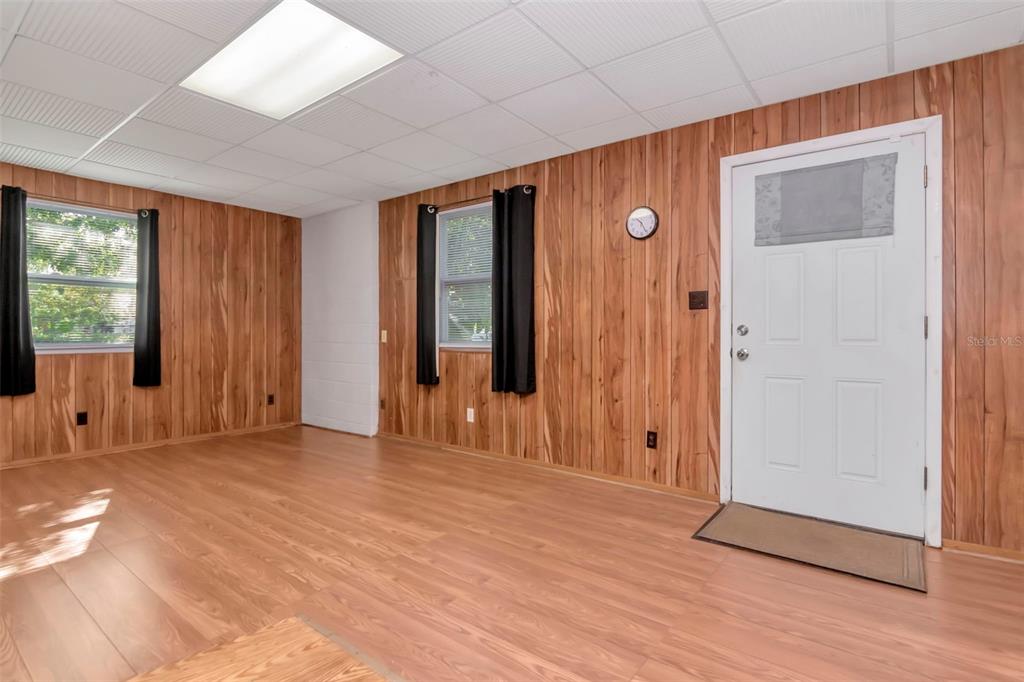 230 Milwaukee Avenue Dunedin, FL 34698 - Photo 20 of 61 an empty room with wooden floor and windows