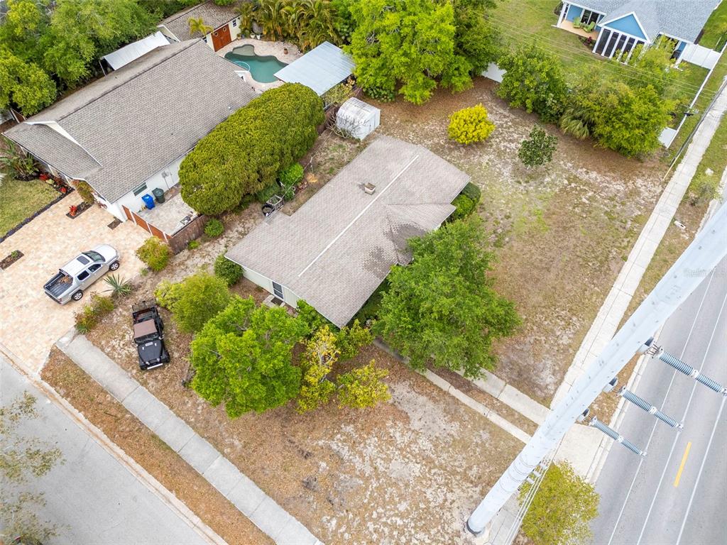 230 Milwaukee Avenue Dunedin, FL 34698 - Photo 2 of 61 an aerial view of a house with a yard and lake view