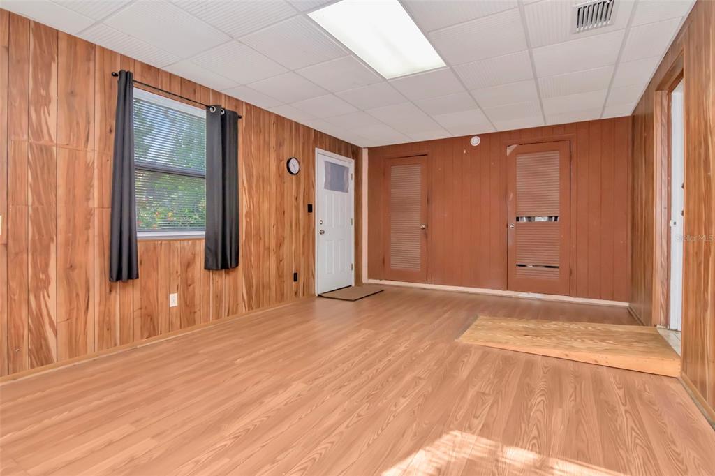 230 Milwaukee Avenue Dunedin, FL 34698 - Photo 23 of 61 a view of an empty room with wooden floor and a window