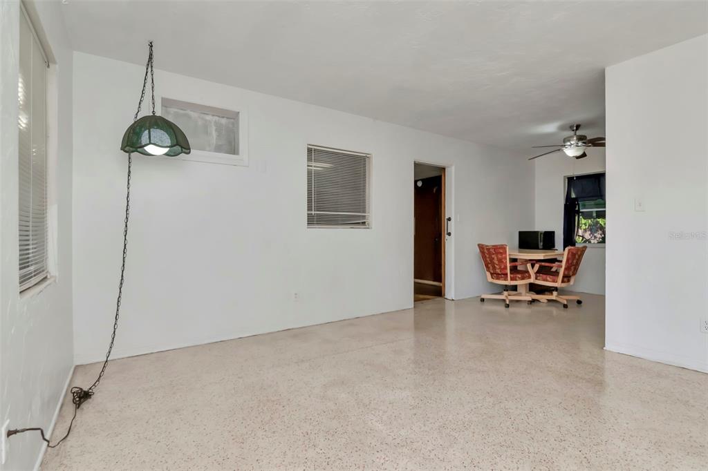 230 Milwaukee Avenue Dunedin, FL 34698 - Photo 27 of 61 a dining room with furniture and a chandelier