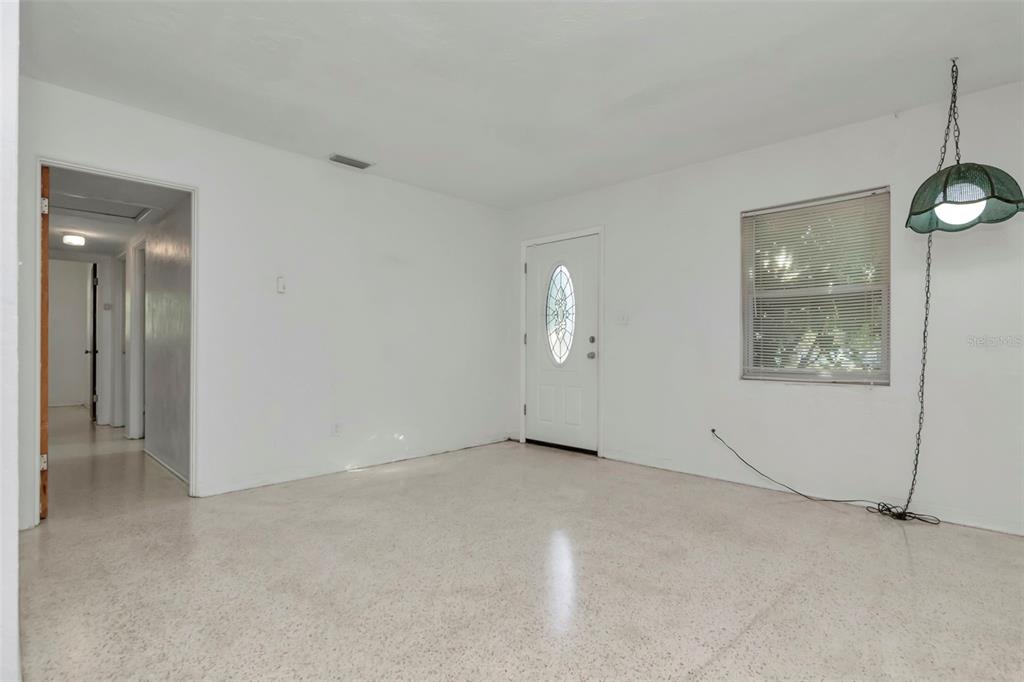 230 Milwaukee Avenue Dunedin, FL 34698 - Photo 31 of 61 an empty room with windows and entrance