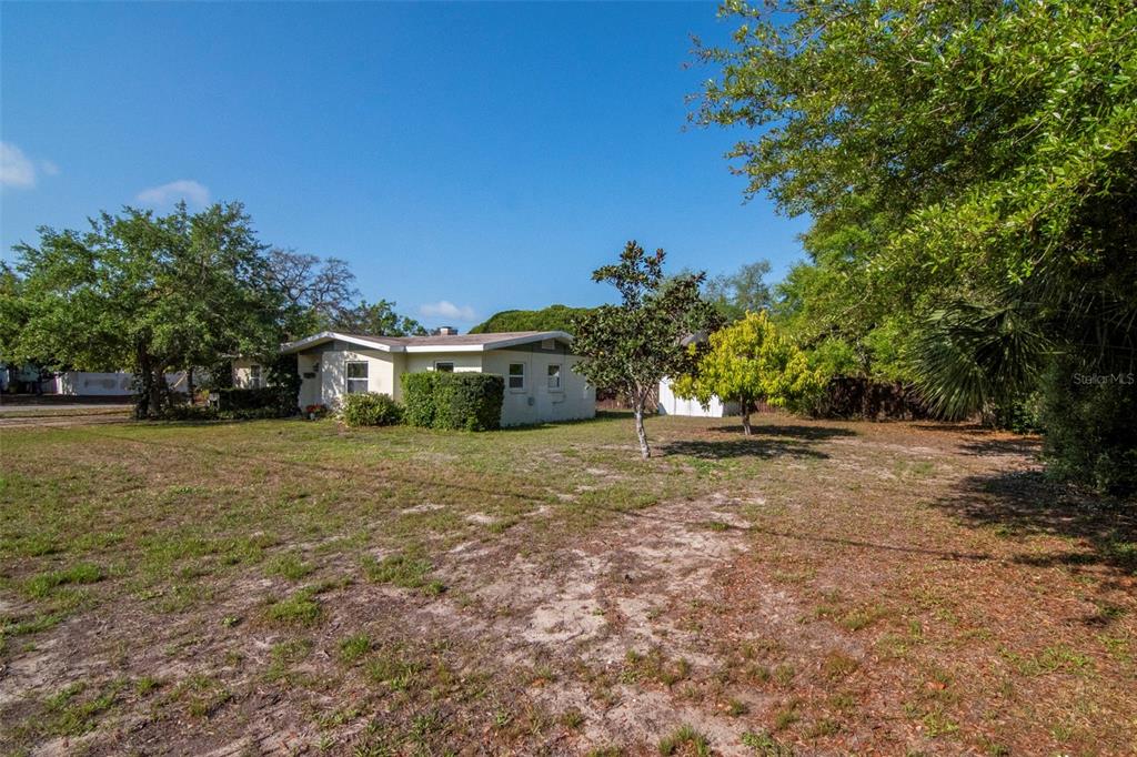230 Milwaukee Avenue Dunedin, FL 34698 - Photo 49 of 61 a front view of a house with a yard