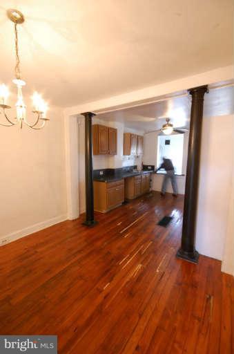 2218 Annapolis Road Baltimore, MD 21230 - Photo 2 of 15 a view of a living room with kitchen island granite countertop wooden floor and a view of kitchen