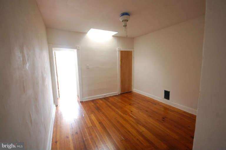 2218 Annapolis Road Baltimore, MD 21230 - Photo 14 of 15 a view of empty room with wooden floor and fan