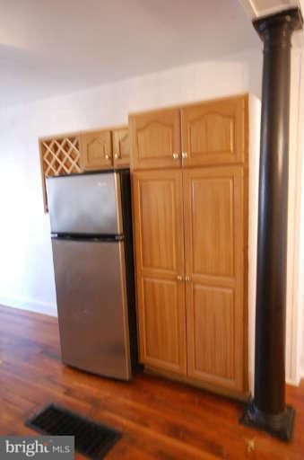 2218 Annapolis Road Baltimore, MD 21230 - Photo 5 of 15 a view of a refrigerator in kitchen with wooden floor
