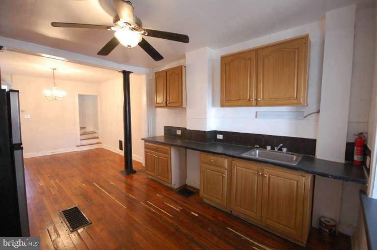 2218 Annapolis Road Baltimore, MD 21230 - Photo 7 of 15 a kitchen with granite countertop a stove a sink and a refrigerator